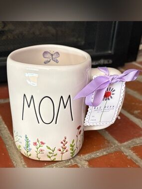 Rae Dunn ceramic mug featuring the word "MOM" and a floral designs MOTHERS DAY
